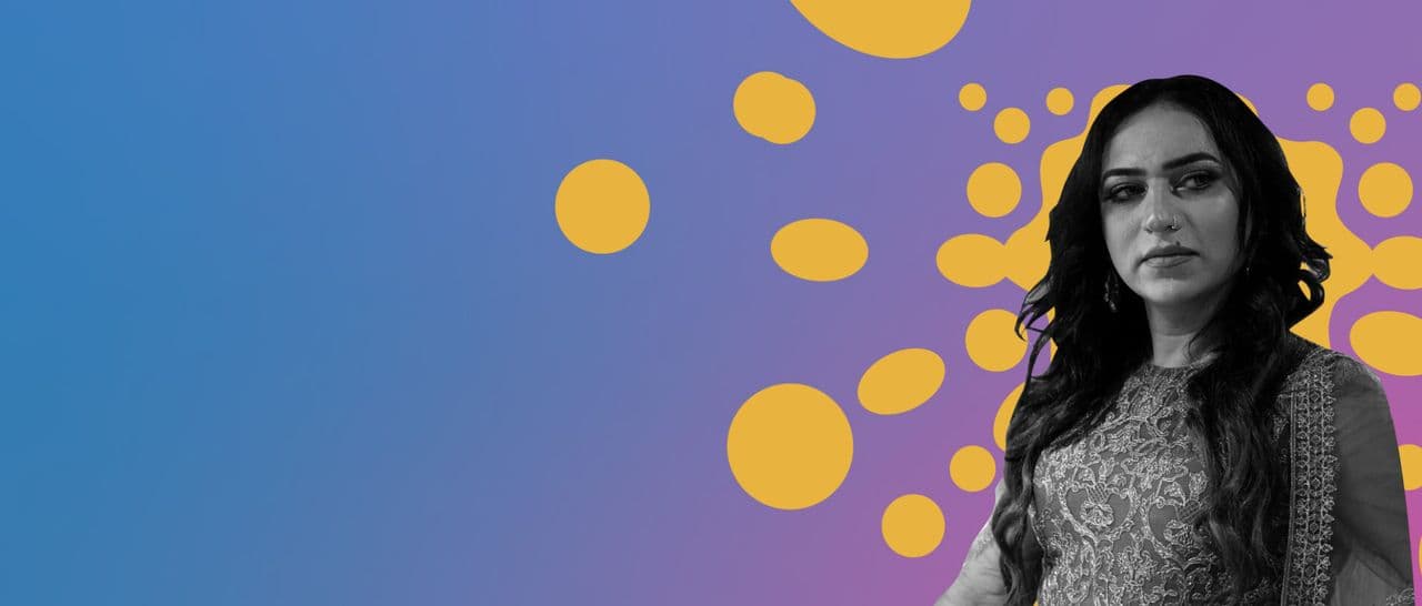 Person in embroidered clothes against a colourful graphic background.