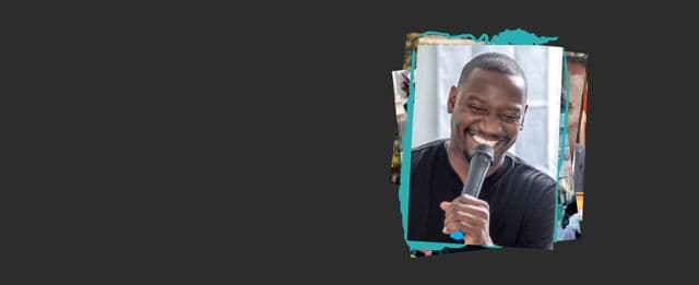 Person smiling while speaking into a microphone.