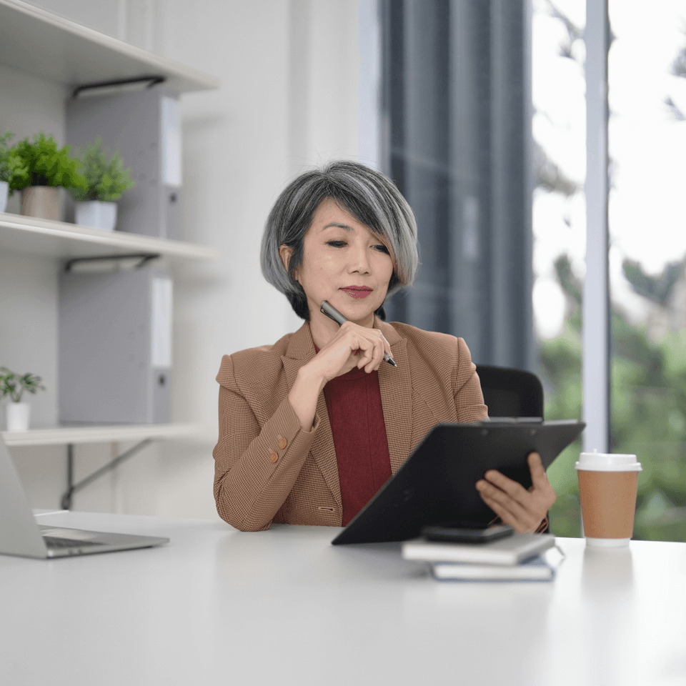 Woman sitting at desk with clipboard