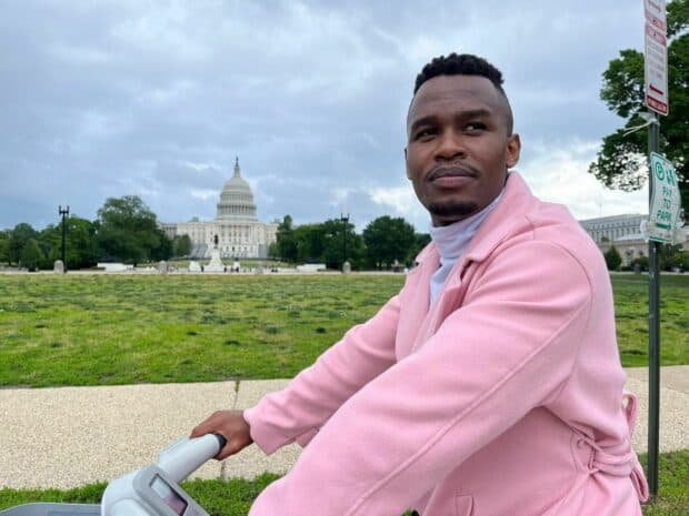 Person in a pink jacket near the U.S. Capitol.