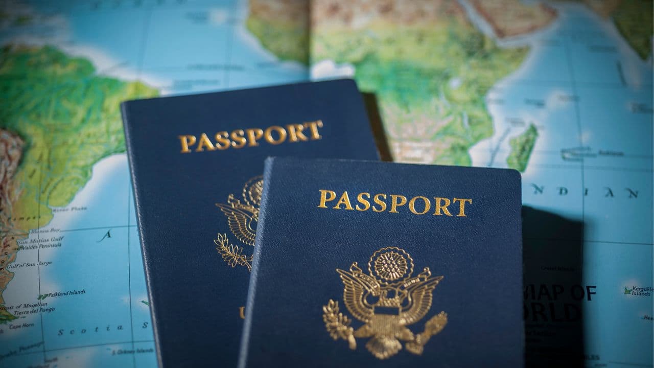 Two passports on top of a world map.