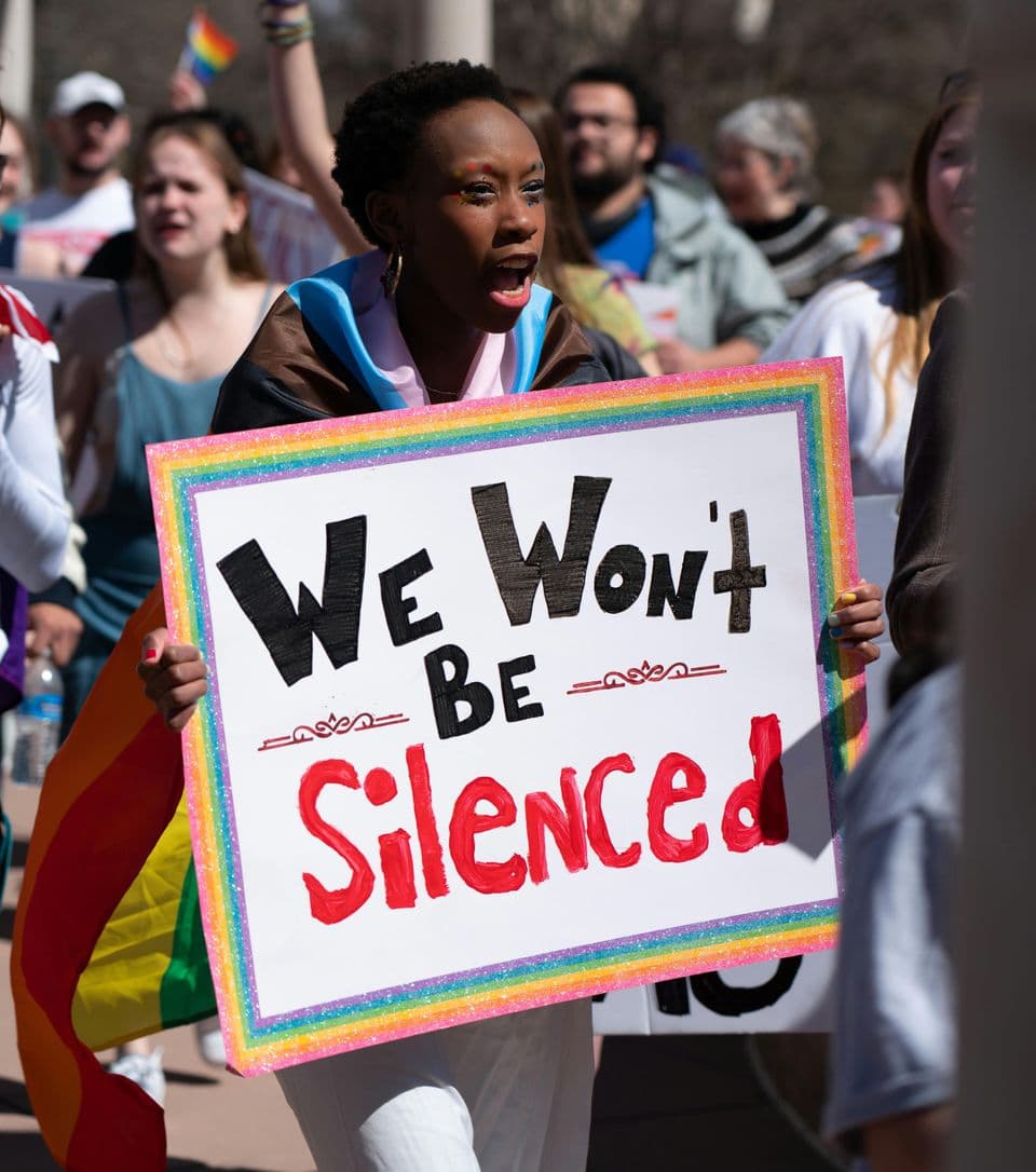 Protester with We Won't Be Silenced sign